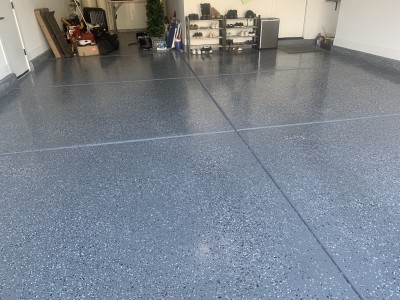 Concrete Garage Floor Epoxy In medium gray and black white color flakes. Topped with a urethane concrete Sealer Clear Coat